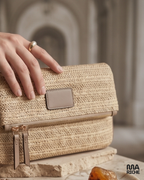 Sac pochette beige tressé pour femme avec chaîne dorée, modèle chic et élégant style été bohème, porté épaule, petit sac bandoulière tendance pour soirée et look casual chic.
